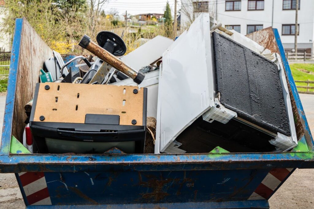 Junk removal services, Brooklyn, NY - crew loading old couch into truck